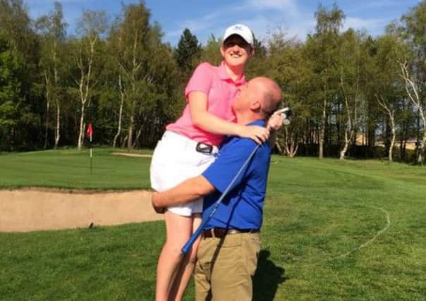 New Yorkshire ladies champion Megan Garland is hoisted aloft by her delighted father Martin, a past York Union player.