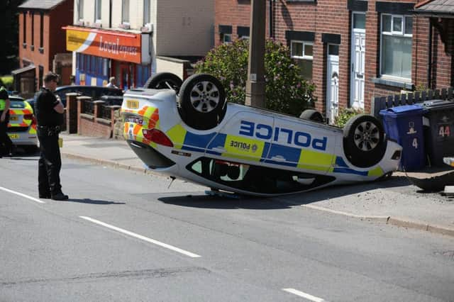 The police car on its roof on Carlton Road, Barnsley. Picture: Ross Parry Agency