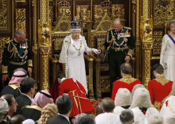 Queen Elizabeth II and the Duke of Edinburgh leave the House of Lords following her speech during the State Opening of Parliament at the Palace of Westminster in London in 2015. Alastair Grant/PA Wire