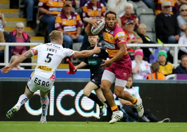 Huddersfield Giants' Leroy Cudjoe skips past St Helens' Adam Swift at St James' Park. Picture: Richard Sellers/PA