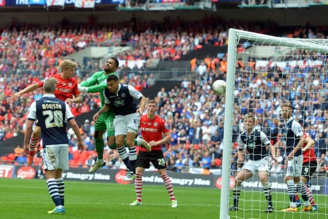 Lloyd Isgrove heads home Barnsleys final goal as they beat Millwall 3-1 in the League One play-off final at Wembley (Picture: Tony Johnson).