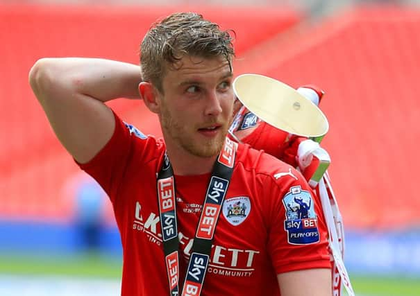 GOING UP: Barnsley strikers Sam Winnall with the trophy after the League One play-off final victory at Wembley. Picture: PA