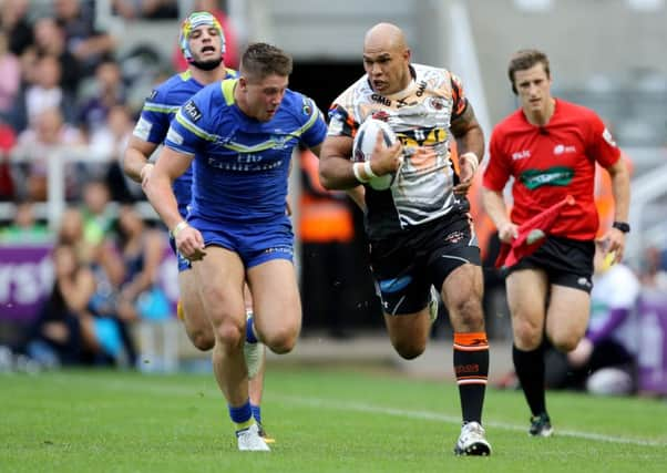 Castleford Tigers' Jake Webster (right) is tackled by Warrington Wolves' Tom Lineham.