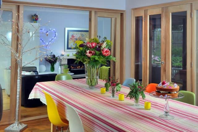 Glazed doors between the sitting room and dining area help distribute light, along with the doors in the hall. The dining table is from Ikea.