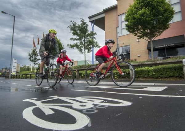 Dom Jacques, of Leeds, with his two children Frankie, 10, and Byron, seven, cycling on the newly opened City Connect route in Thornbury. Picture by James Hardisty.