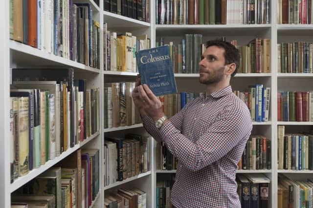 James Hallgate  of Lucius Book  looking at The Colossus, one of a tri oof rare books, showcased at the Antiques For Everyone Summer Fair held at NEC Birmingham. Picture James Hardisty