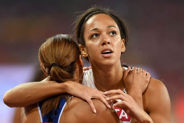 TEAM-MATES: Katarina Johnson-Thompson embraces her inspiration and Sheffields Olympic heptathlete champion Jessica Ennis-Hill after competing in the 200m at the World Athletics Championships in Beijing last year.  Picture: Adam Davy/PA