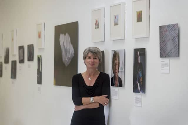 Dr Lee Karen Stow standing by a picture of her late mum Maureen who survived the Hull Blitz.