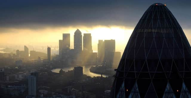 The 'Gherkin' and Canary Wharf at sunrise in the City of London