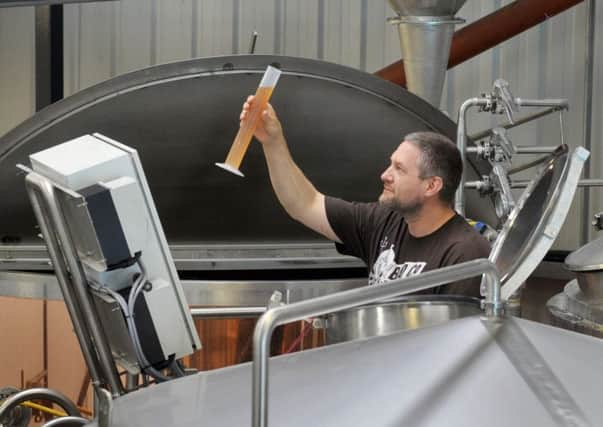 Paul Holden-Ridgeway Head Brewer  of  The Bad Co Brewing and Distilling  at Dishforth  checking on the latest brew(Gl1010/52h)