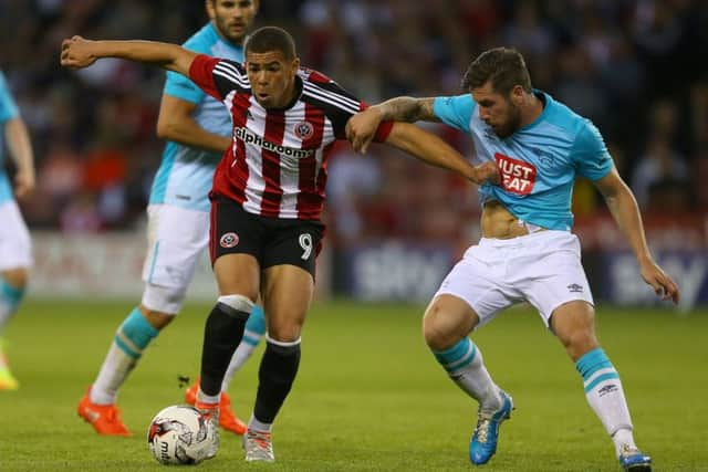 Che Adams of Sheffield Utd tussles with Jacob Butterfield of Derby County during the pre season friendly on Wednesday night. 2016. Pic Simon Bellis/Sportimage