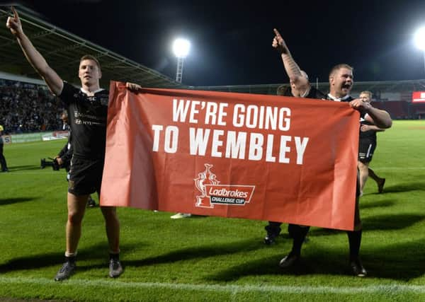 Hull celebrate their 16-12 victory and a place in the Challenge Cup Final at Wembley.