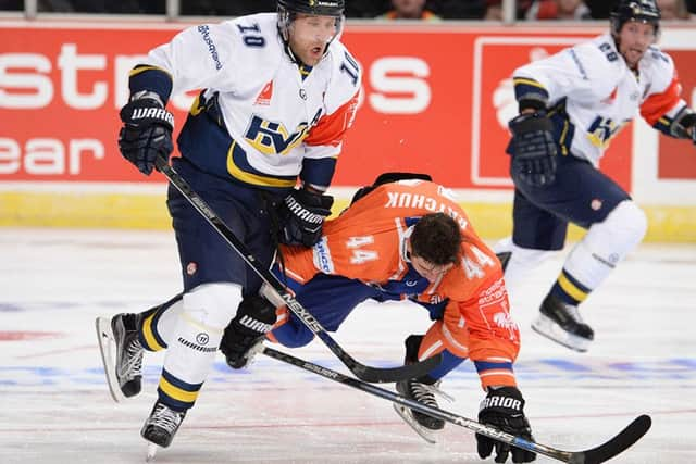 DOWN BUT NOT QUITE OUT: Steelers' Mike Ratchuk takes a tumble under pressure from HV71's Martin Tornberg. Picture: Dean Woolley.