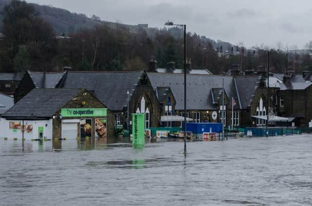 The flooded Co-op and Burnley Road, Mytholmroyd, last December