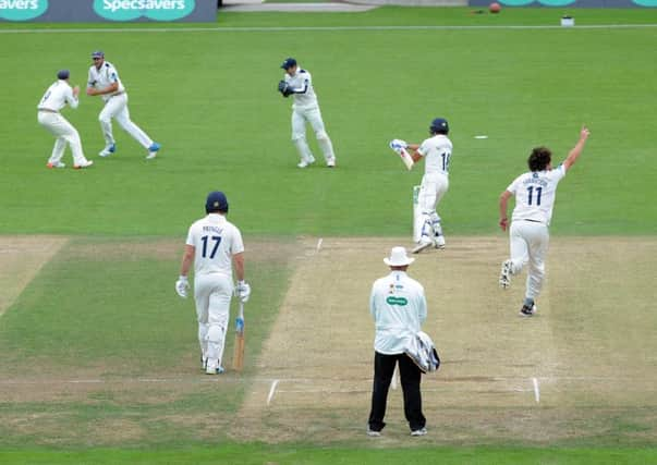 GOTCHA: Ryan Sidebottom celebrates after Tim Bresnan, second left, takes the catch to dismiss Durham's Michael Richardson. Picture: Steve Riding.