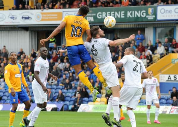 Mansfield Town v Barnet.
Matt Green rises high above Barnet's captain, Michael Nelson.