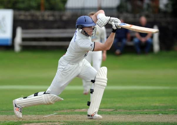 BOUNDARY DRIVE: Pudsey St Lawrences Adam Waite hits a four as his side go on to clinch the Bradford League title. Picture: Steve Riding