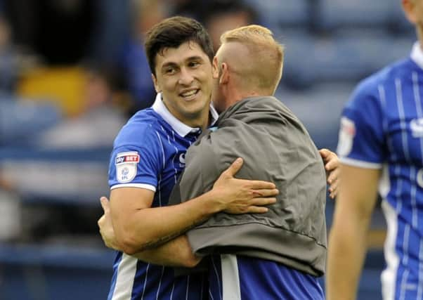 Barry Bannan, back to camera, hugs Fernando Forestieri, Sheffield Wednesdays match-winner against Wigan on Saturday (Picture: Steve Ellis).