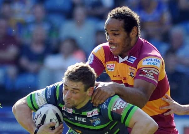 Huddersfield Giants' Leroy Cudjoe collars Leeds Rhinos' Jimmy Keinhorst during the game at the weekend (Picture: Tony Johnson).