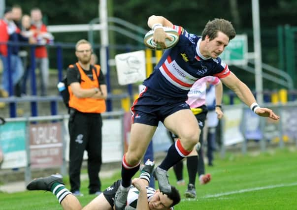 David Clark of Doncaster Knights leaves William Millett of Nottingham on the floor as he breaks away.