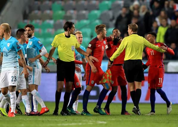 Tempers flare between England's Jesse Lingard (right) and Slovenia's Aljaz Struna (left).