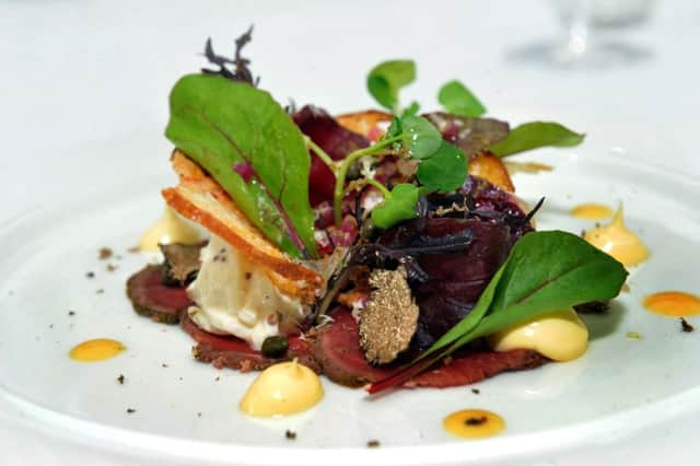 A starter of Fillet Beef Carpaccio, Truffle Egg Yolk, Sourdough Crisp, Celeriac Remoulade  at The Cleveland, Tontine near Northallerton.