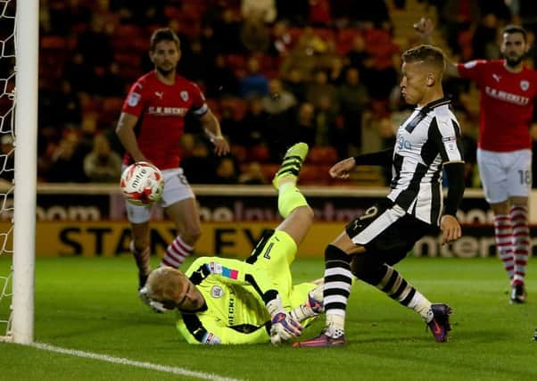 Newcastle United's Dwight Gayle scores his opening goal during the Sky Bet Championship match at Oakwell, Barnsley.