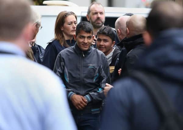 Teenagers (centre) arrive at Lunar House in Croydon, south London, from the "Jungle" camp in Calais.