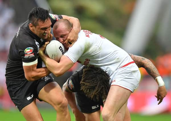 England's Dan Sarginson is tackled by New Zealand's Thomas Leuluai.