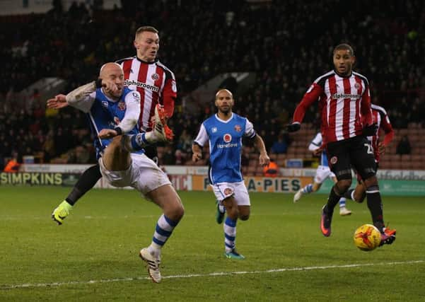 Caolan Lavery of Sheffield United puts pressure on the Walsall defence during the League One match at Bramall Lane on Tuesday. (Picture: Simon Bellis/Sportimage)