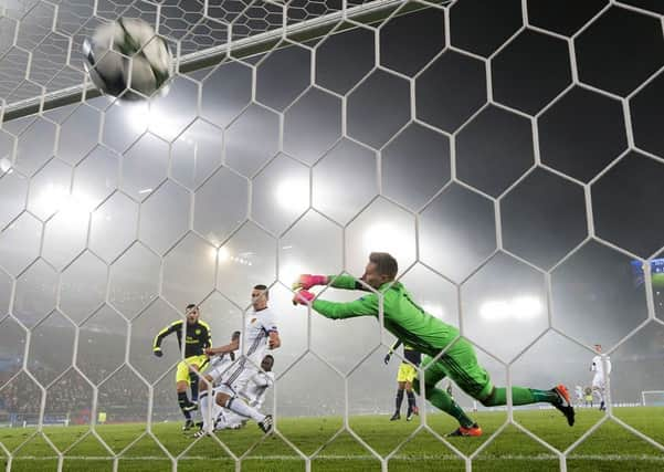 Arsenal's Lucas Perez, left, scores against Basle.