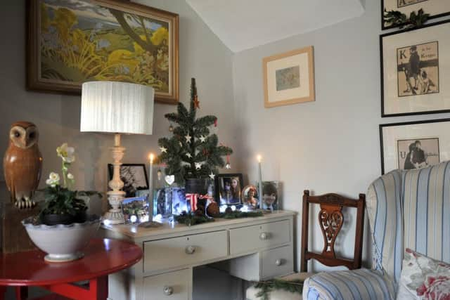 The mini tree is a branch planted in a plant pot full of sand. On the right are the Alphabet prints by William Nicholson