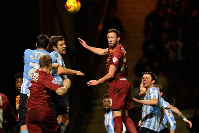 Rory McArdle rises for a corner ball.