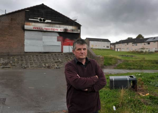 Community leader Bill Graham pictured outside the former Wellington Stores shop.