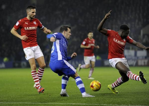 Thick of the action: Sheffield Wednesday substitute Ross Wallace whips in a cross against Barnsley. (Picture: Steve Ellis)