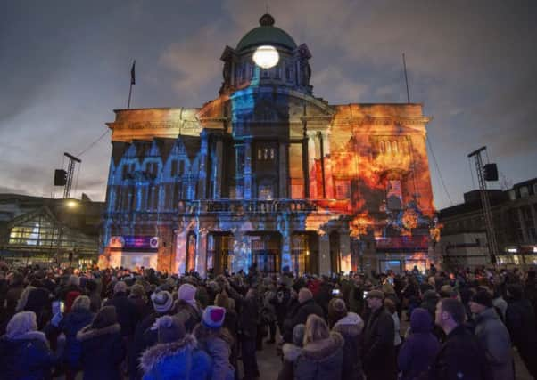 Visitors looking at the projections onto City Hall. Mark Bickerdike