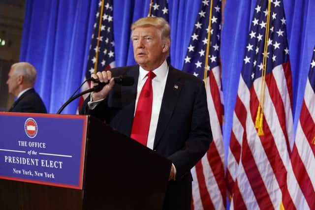 President-elect Donald Trump arrives for a news conference in the lobby of Trump Tower in New York