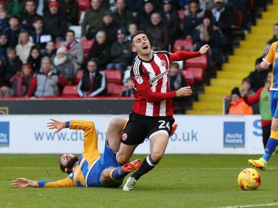 Daniel Lafferty si brought down  by Shrewsbury Town's Jim O'Brien (Photo: Sportimage)