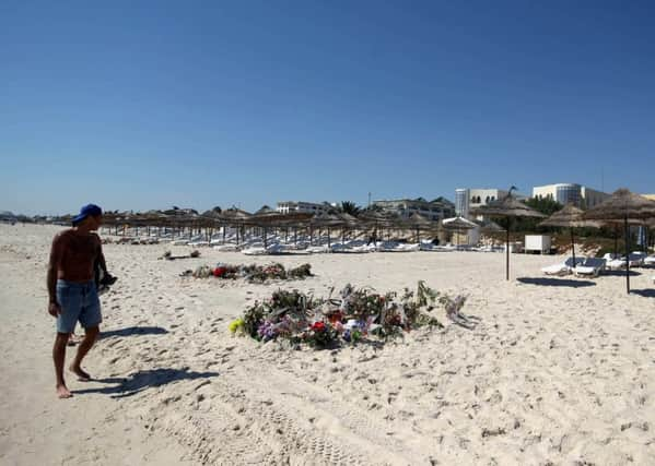 Flowers on the beach near the RIU Imperial Marhaba hotel in Sousse, Tunisia, the scene of the massacre. Inquests into the deaths of the 30 Britons killed will begin today. Pic: Steve Parsons/PA Wire