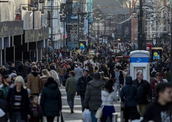 Shoppers pictured in Briggate, where giant 'planters' have been installed to stop heavy vehicles entering.