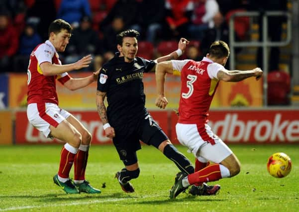 COMING THROUGH: Barnsley's Adam Hammill challenged between Rotherham's Richie Smallwood and Joe Mattock.. Picture: Jonathan Gawthorpe