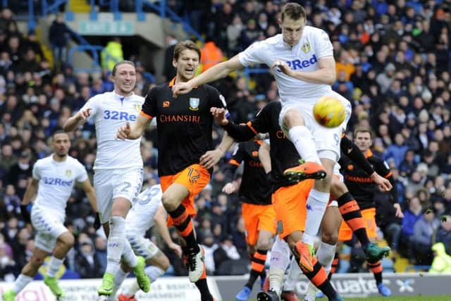 Leeds United's Chris Wood clears Sheffield Wednesday captain, Glenn Loovens. Picture: Steve Ellis