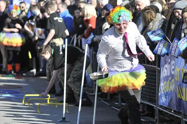 Residents took part in the entertaining pancake racing.