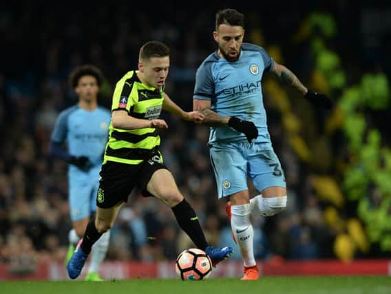 Jack Payne sprints keeps the ball away from Nicolas Otamendi