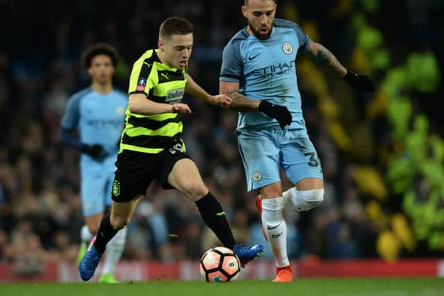 MIDFIELD BATTLE: Huddersfield's Jack Payne goes clear of Nicolas Otamendi.  Picture: Bruce Rollinson