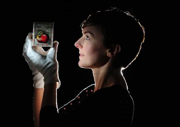 Curator Katie Brown with a Terrys Desert Chocolate Apple from 1926. Picture by Simon Hulme