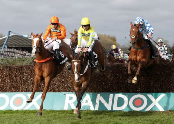 Brian Hughes on board Double W's (left) wins the Betway Red Rum Handicap Chasel at Aintree.