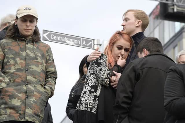 A couple embrace after the truck crashed into the store. Picture: Anders Wiklund/ TT News Agency via AP