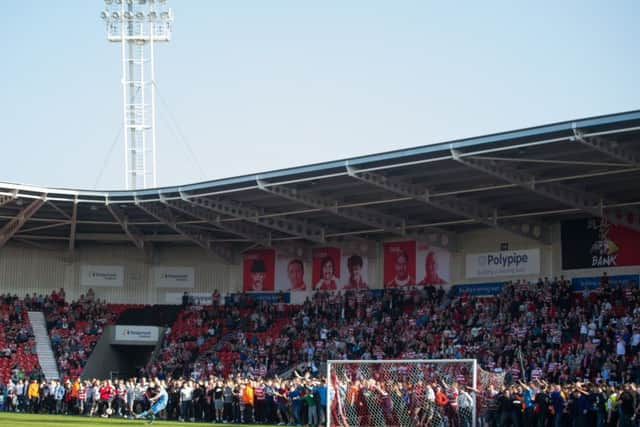 Rovers fans invade the pitch at full-time. (Picture: PA)