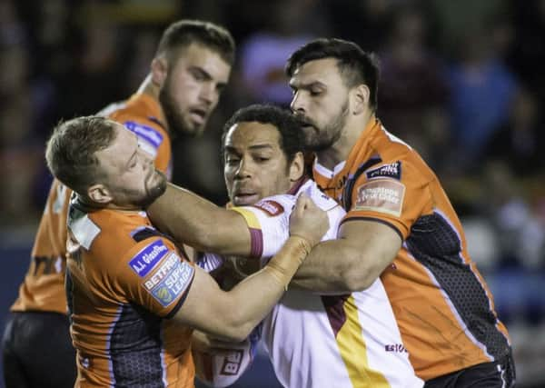 Huddersfield's Leroy Cudjoe is tackled by Castleford's Paul McShane and Matt Cook. (SWPix.com)